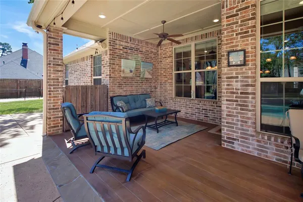 a balcony with furniture and a potted plant