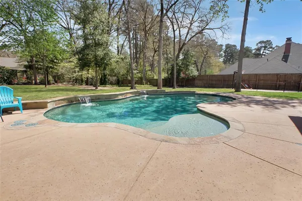 a view of a swimming pool and a yard