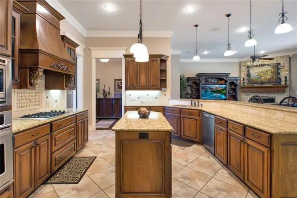 a large kitchen with stainless steel appliances kitchen island granite countertop a stove a sink a oven and a refrigerator