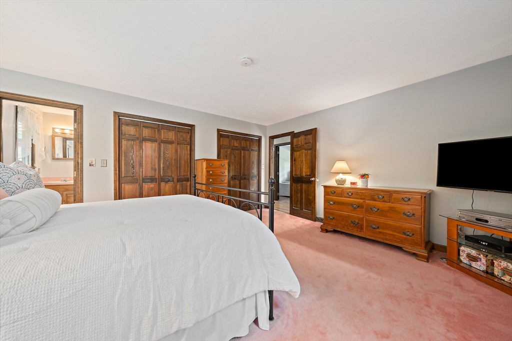 7 Josephine Street Canton, MA 02021 - Photo 18 of 30 a spacious bedroom with a bed and a flat screen tv