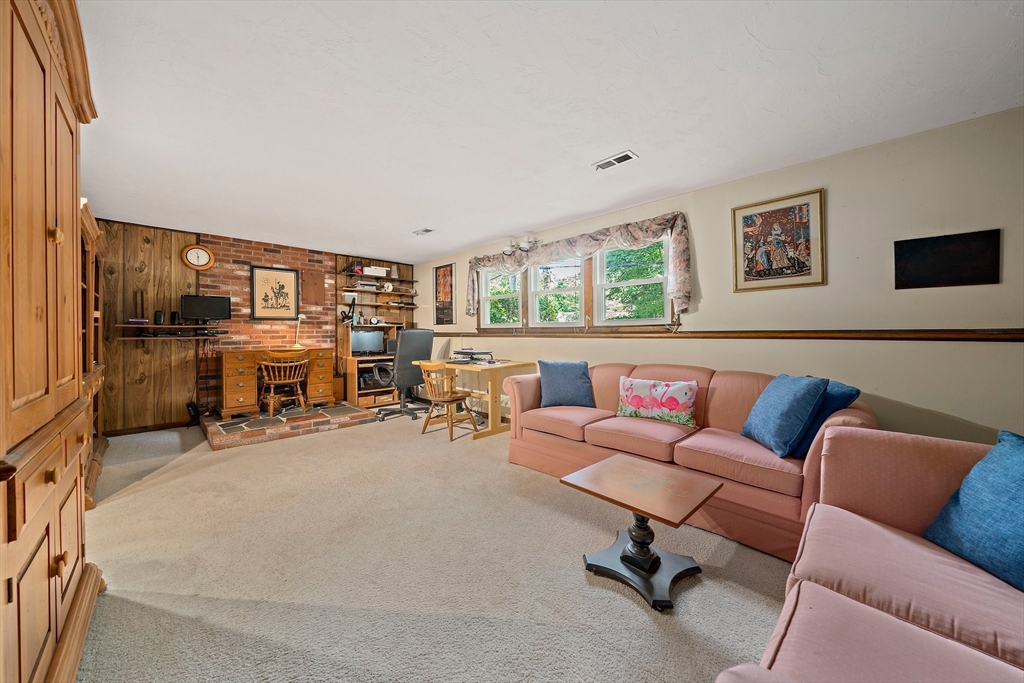 7 Josephine Street Canton, MA 02021 - Photo 24 of 30 a living room with furniture a fireplace and a large window