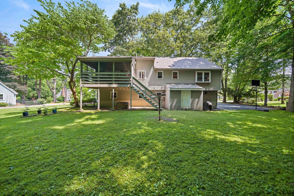 7 Josephine Street Canton, MA 02021 - Photo 28 of 30 a view of a house with a big yard potted plants and large tree