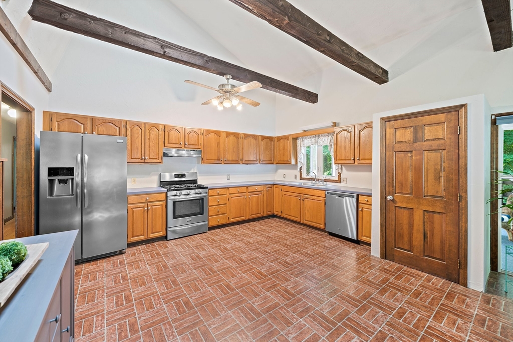 7 Josephine Street Canton, MA 02021 - Photo 4 of 30 a kitchen with granite countertop a sink stainless steel appliances and counter top space