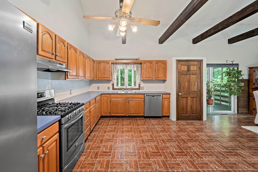 7 Josephine Street Canton, MA 02021 - Photo 5 of 30 a kitchen with stainless steel appliances granite countertop a sink a stove a refrigerator cabinets and living room view