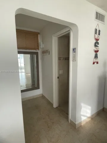 a bathroom with a granite countertop toilet sink and mirror