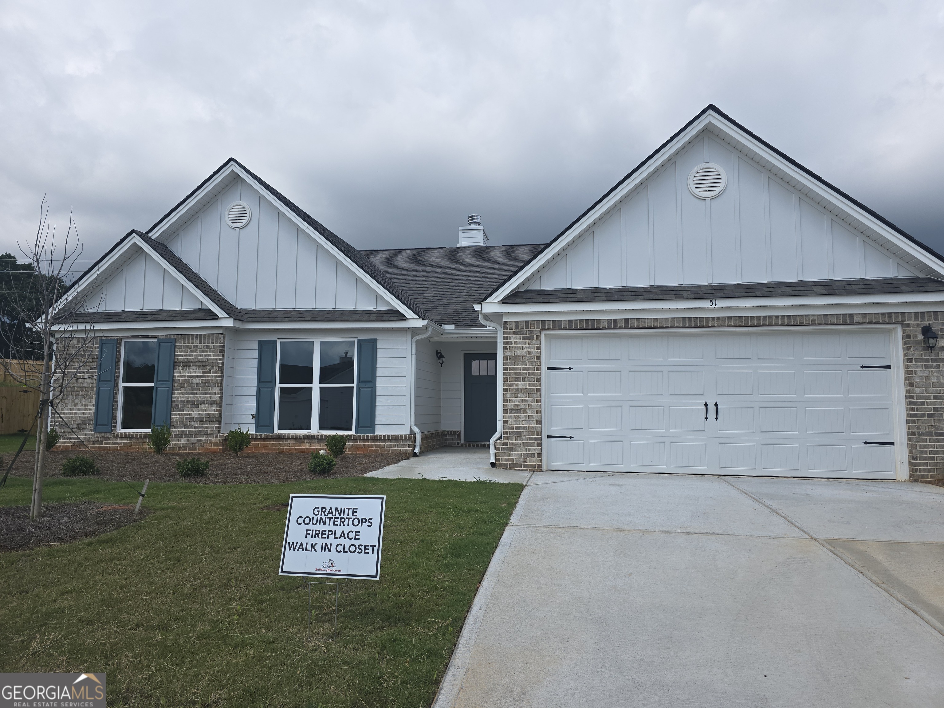 a view of a house with a yard and garage