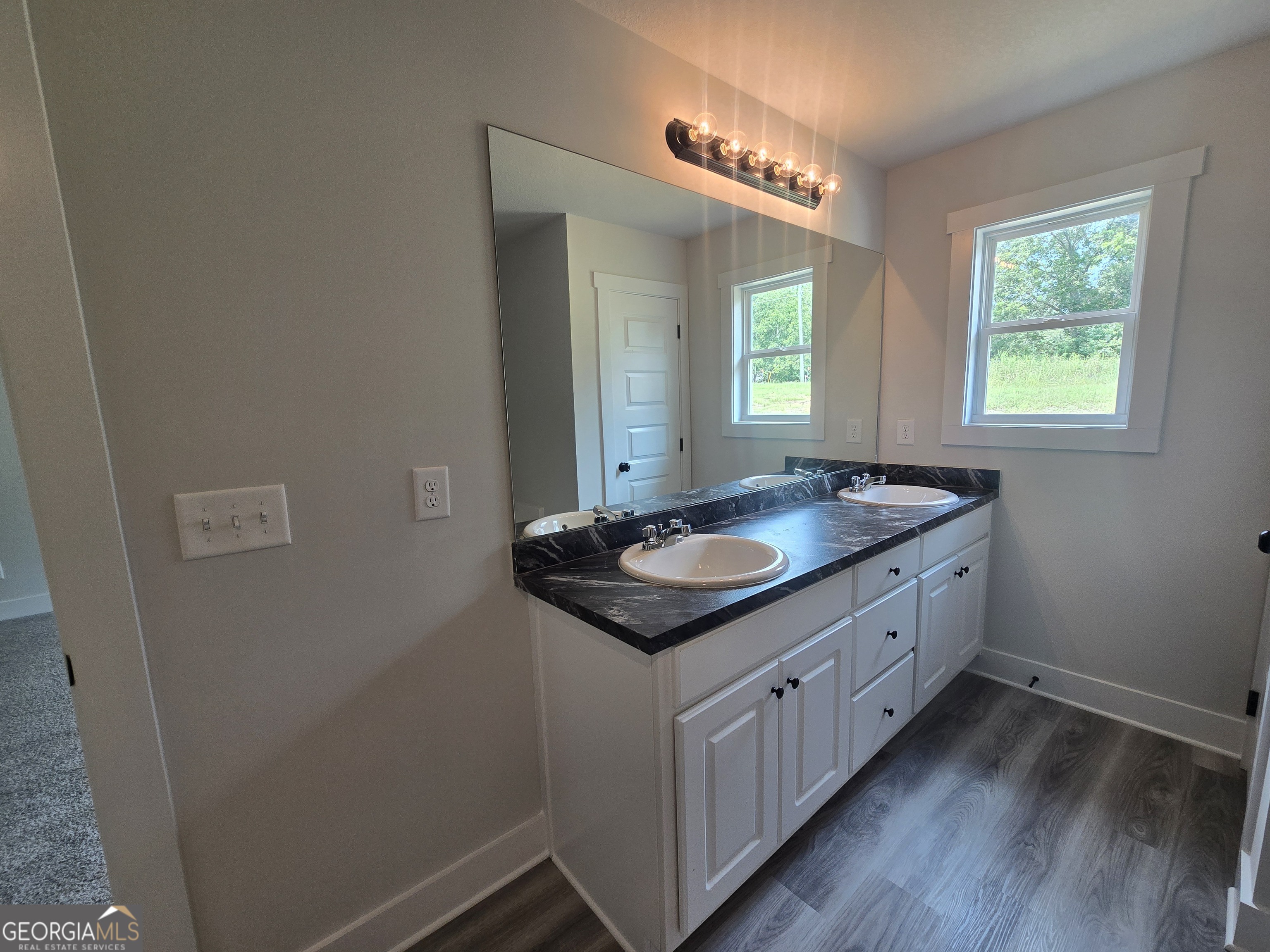 51 Champions Lane, Unit 2 Winder, GA 30680 - Photo 12 of 16 a bathroom with a granite countertop sink and a mirror