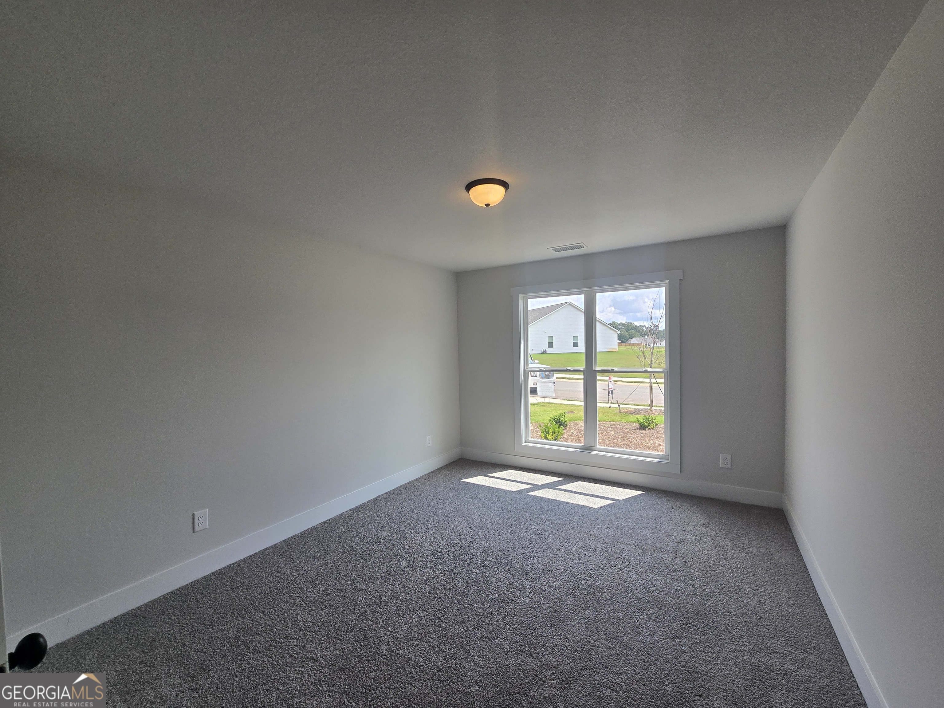 51 Champions Lane, Unit 2 Winder, GA 30680 - Photo 5 of 16 an empty room with a window