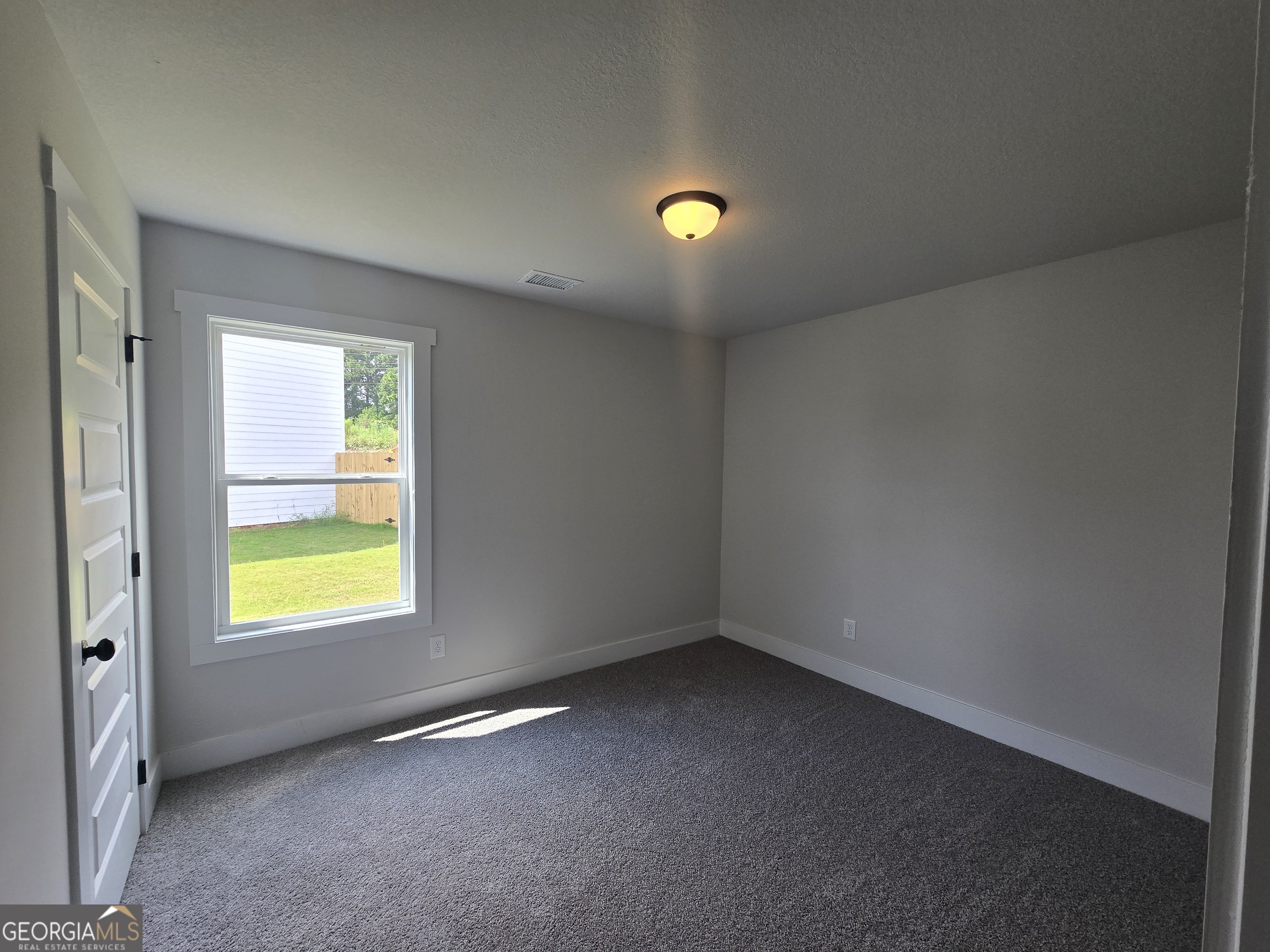 51 Champions Lane, Unit 2 Winder, GA 30680 - Photo 7 of 16 an empty room with window and painted walls