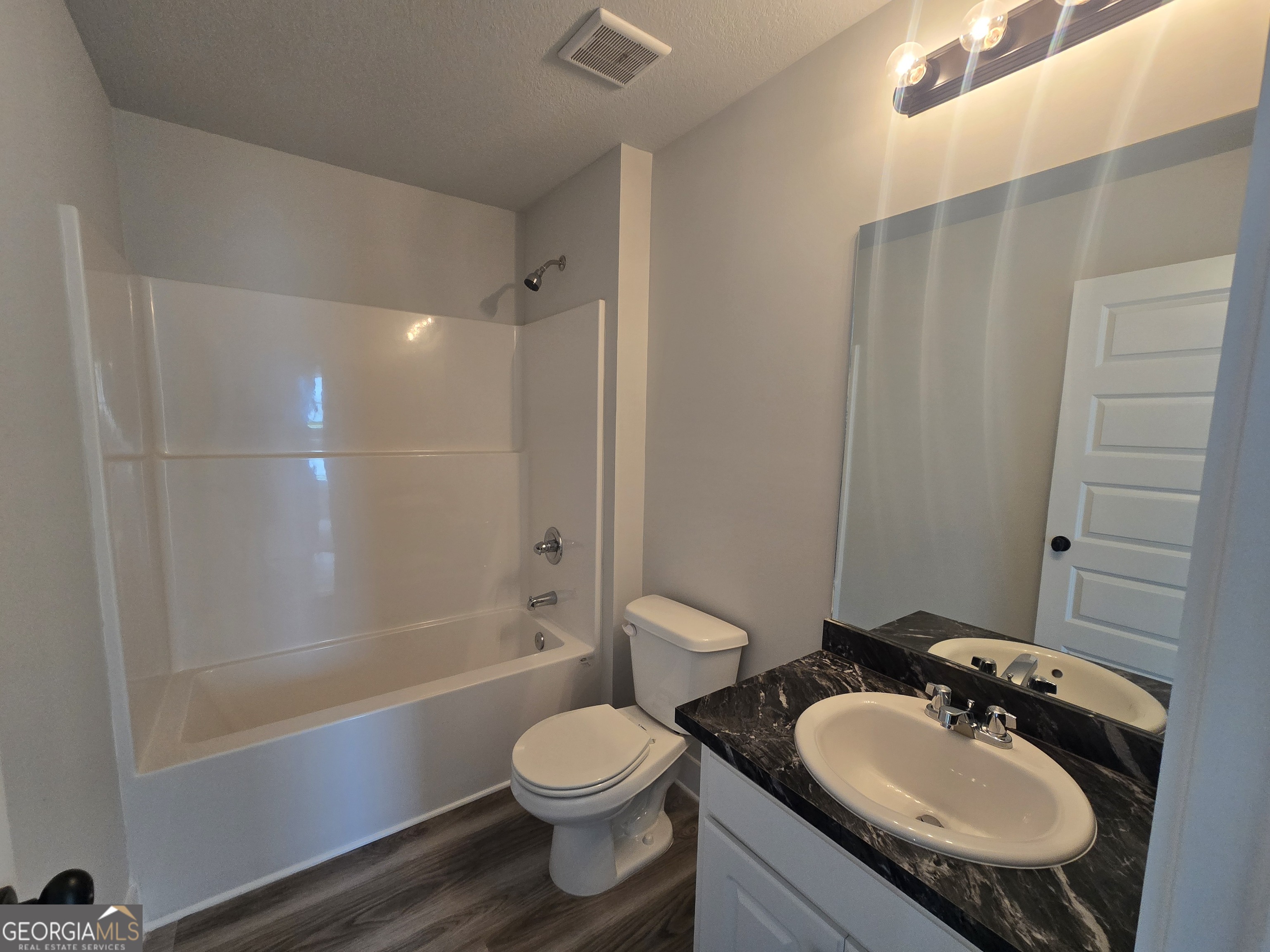 51 Champions Lane, Unit 2 Winder, GA 30680 - Photo 9 of 16 a bathroom with a sink toilet a mirror and shower