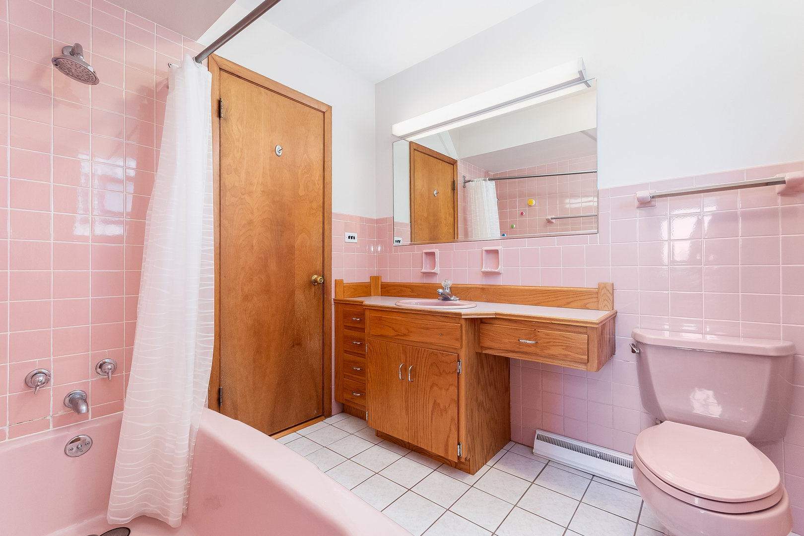 8 South Mt Prospect Road Mount Prospect, IL 60056 - Photo 13 of 25 a bathroom with a sink a toilet a mirror and shower