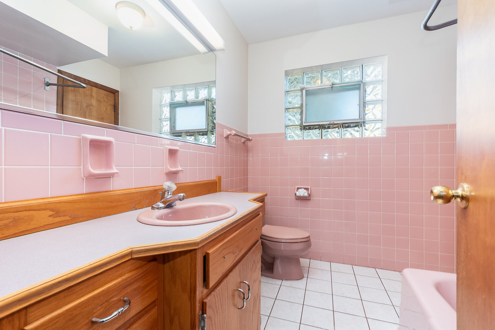 8 South Mt Prospect Road Mount Prospect, IL 60056 - Photo 14 of 25 a bathroom with a sink a toilet and mirror