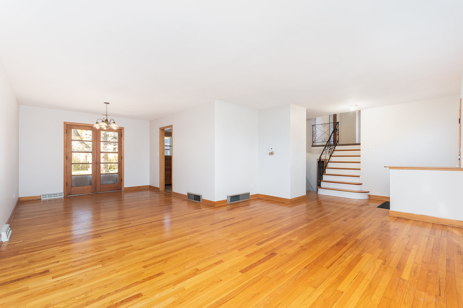 8 South Mt Prospect Road Mount Prospect, IL 60056 - Photo 3 of 25 a view of empty room with wooden floor and fan