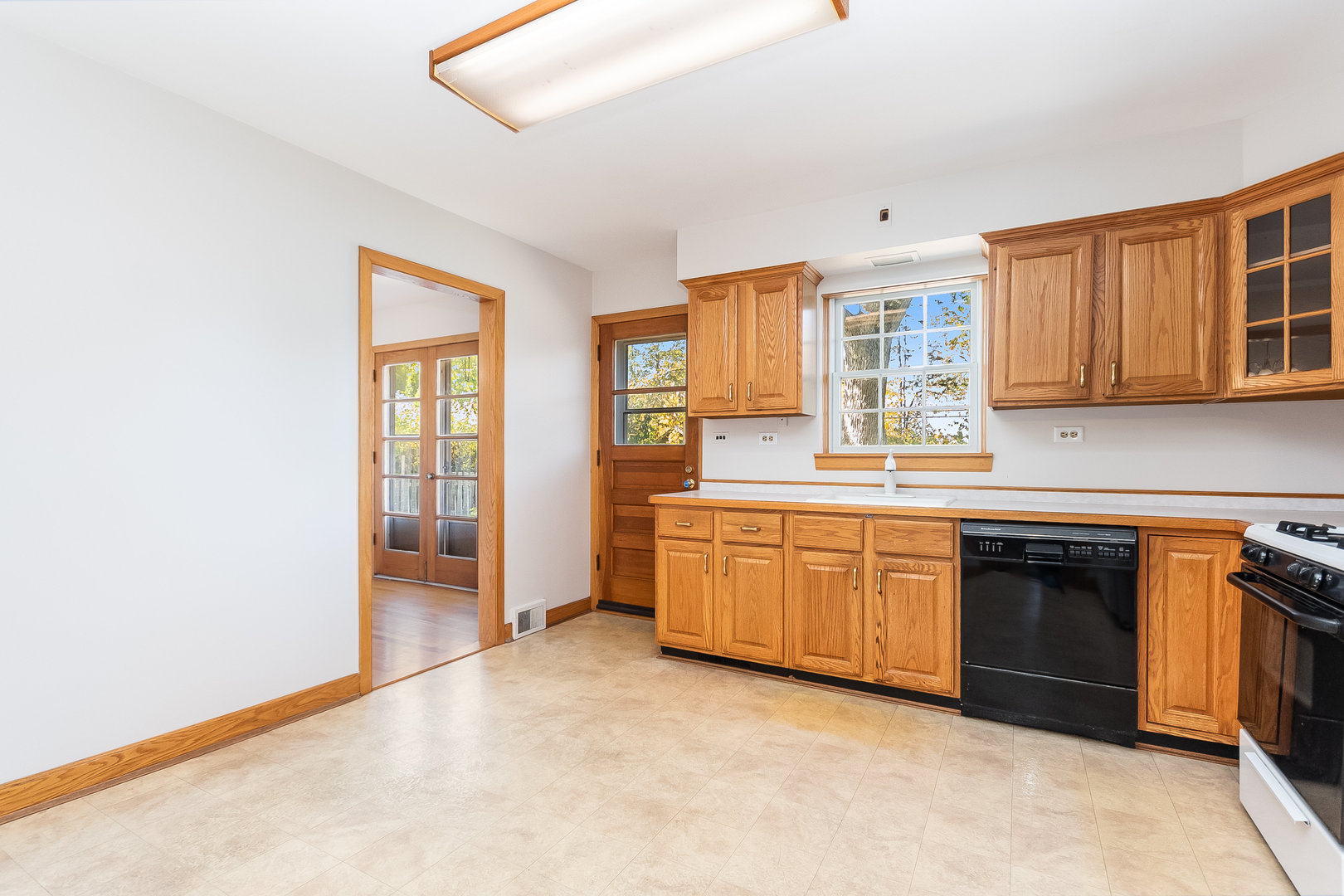 8 South Mt Prospect Road Mount Prospect, IL 60056 - Photo 6 of 25 a kitchen with granite countertop a stove a sink and a refrigerator