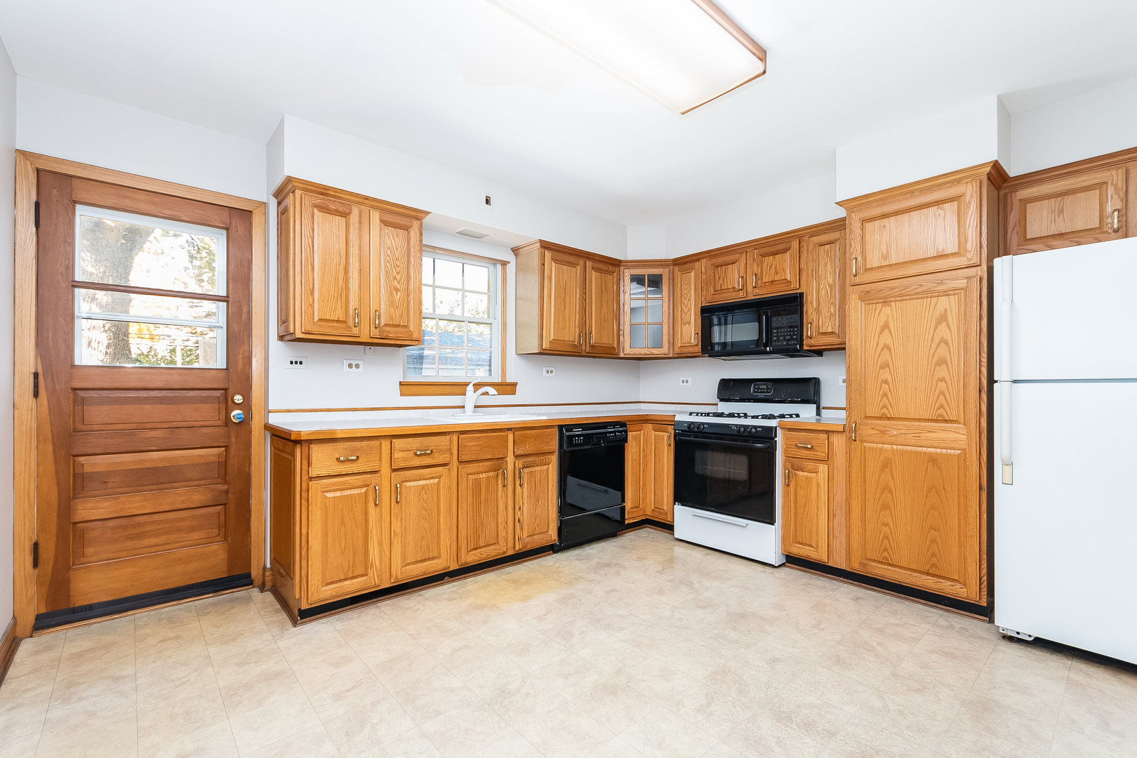 8 South Mt Prospect Road Mount Prospect, IL 60056 - Photo 7 of 25 a kitchen with stainless steel appliances granite countertop a refrigerator and a stove top oven
