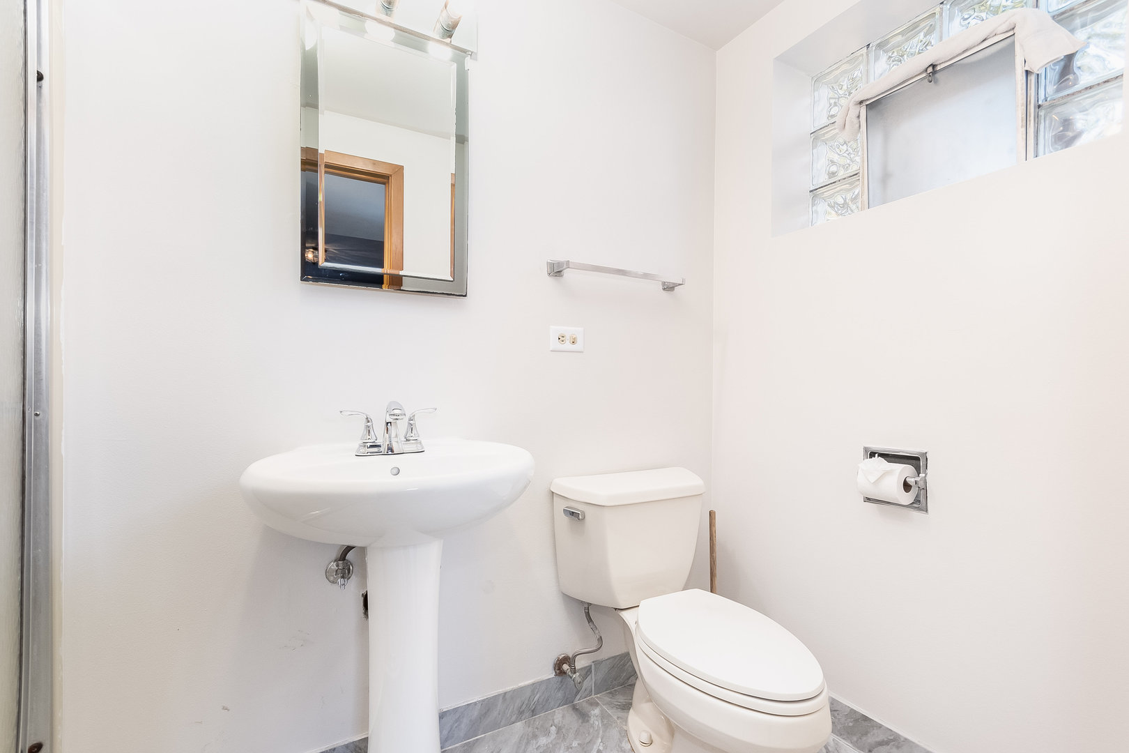 8 South Mt Prospect Road Mount Prospect, IL 60056 - Photo 9 of 25 a white toilet sitting next to a bathroom sink