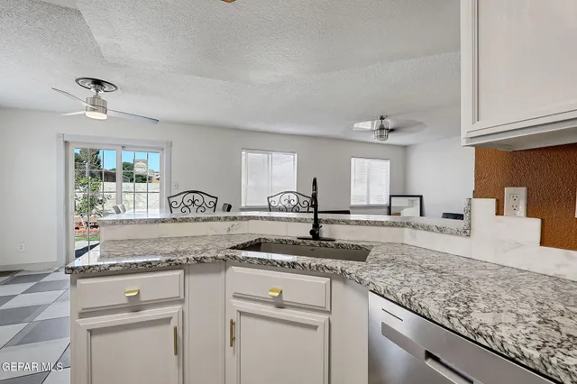 a kitchen with stainless steel appliances granite countertop a stove and a microwave