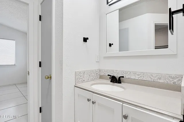 a bedroom with a bed and cabinets