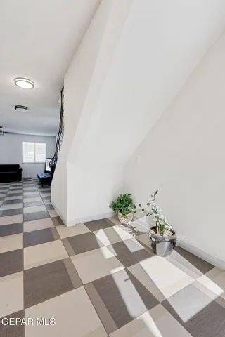 a view of a bedroom with a bed and wooden floor