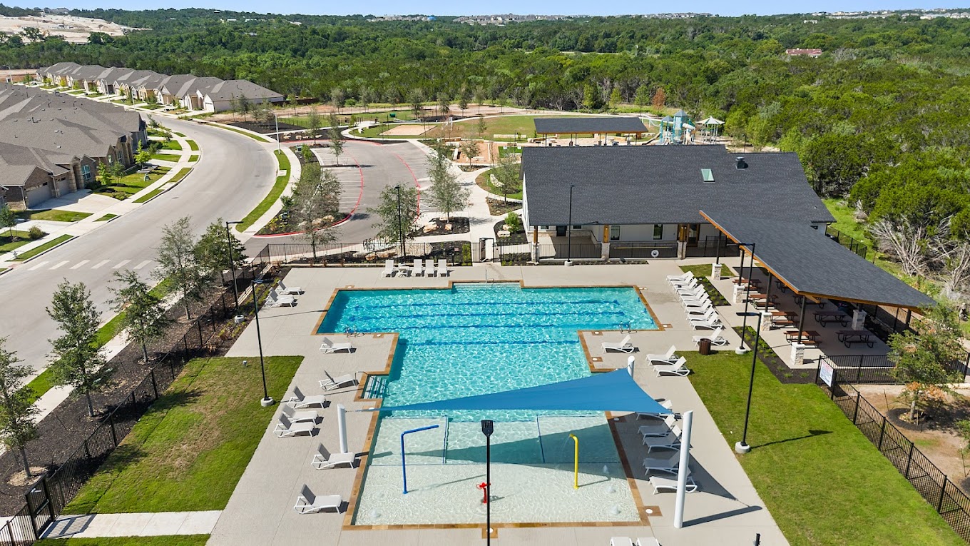 1909 Ruger Pass Leander, TX 78641 - Photo 28 of 31 Community pool featuring a patio area and a wooded view