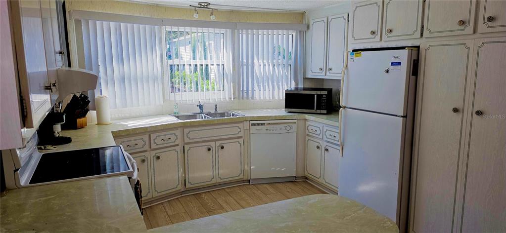 2331 Belleair Road, Unit 806 Clearwater, FL 33764 - Photo 11 of 23 a kitchen with a refrigerator sink and cabinets