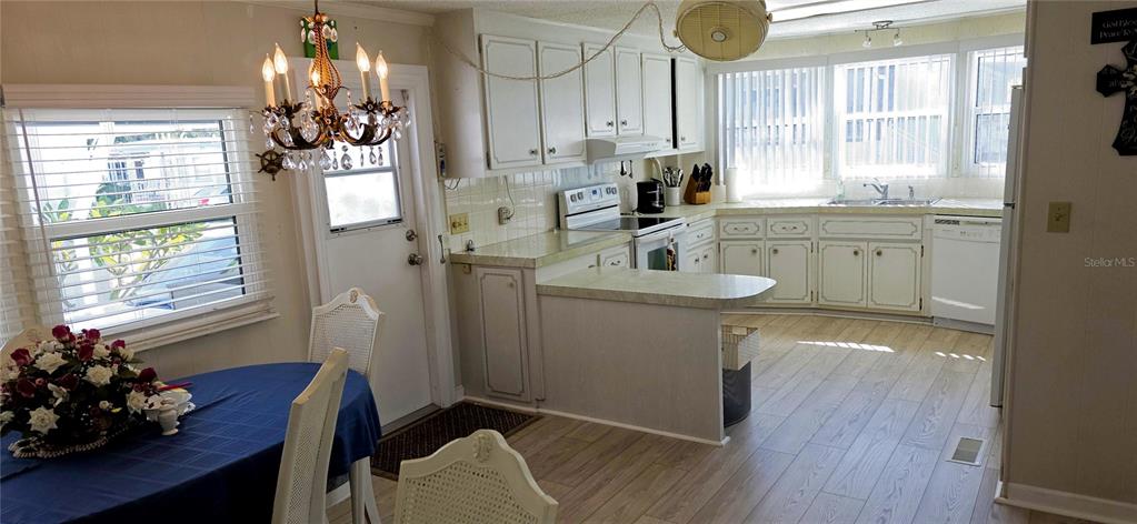 2331 Belleair Road, Unit 806 Clearwater, FL 33764 - Photo 18 of 23 a room with stainless steel appliances a white furniture wooden floor and a window