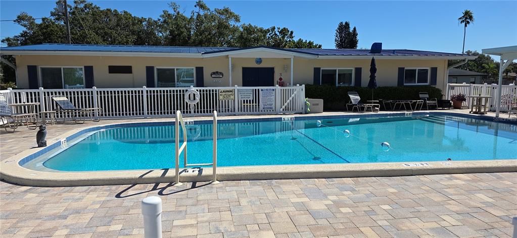 2331 Belleair Road, Unit 806 Clearwater, FL 33764 - Photo 19 of 23 a front view of house and yard with swimming pool