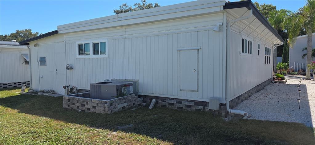 2331 Belleair Road, Unit 806 Clearwater, FL 33764 - Photo 4 of 23 a backyard of a house with table and chairs