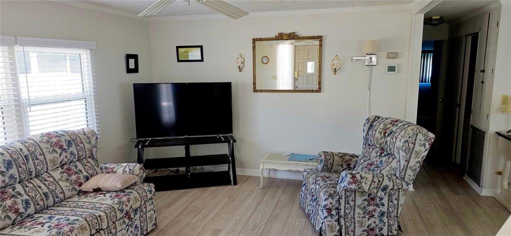 2331 Belleair Road, Unit 806 Clearwater, FL 33764 - Photo 8 of 23 a living room with furniture a flat screen tv and a window