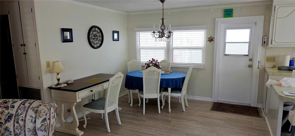 2331 Belleair Road, Unit 806 Clearwater, FL 33764 - Photo 9 of 23 a view of a dining room with furniture window and wooden floor