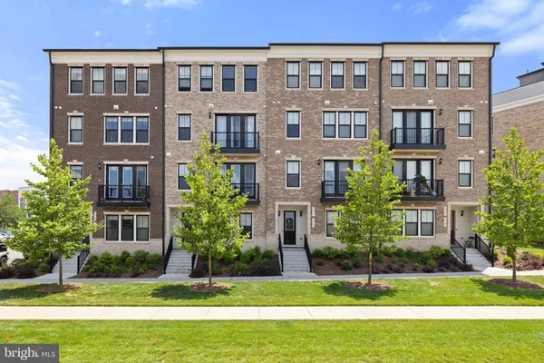 a front view of a building with a yard