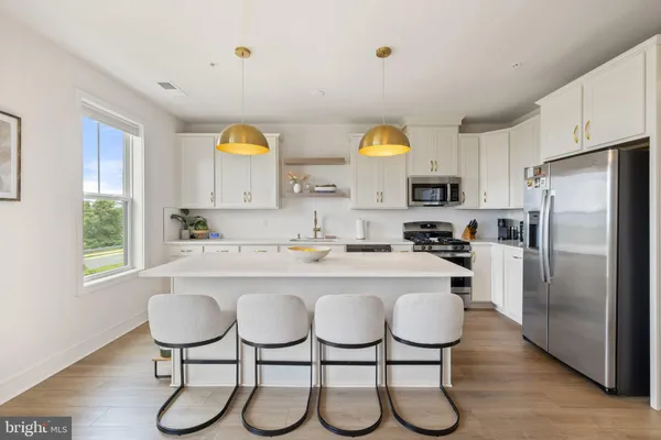 a kitchen with a refrigerator and windows