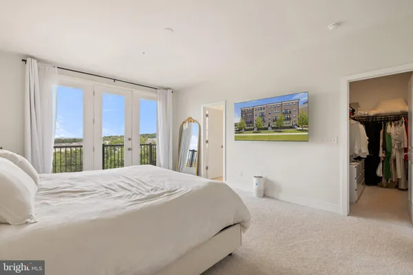 a bedroom with a large bed and a large window