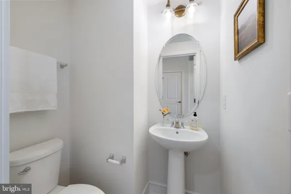 a bathroom with a sink a toilet and mirror