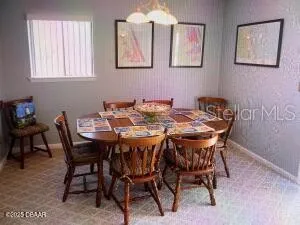 a view of a dining room that has a table and chairs in it