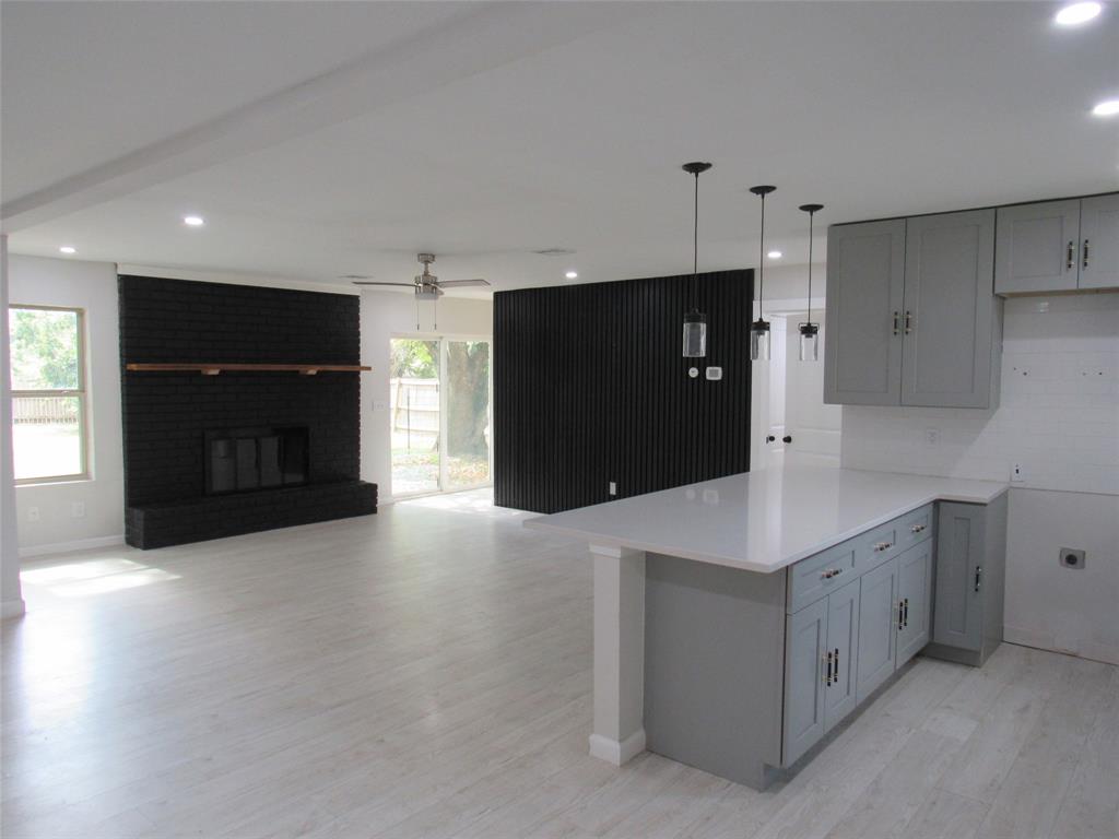 321 Crescent Drive Hewitt, TX 76643 - Photo 3 of 21 a kitchen with stainless steel appliances a refrigerator and a microwave