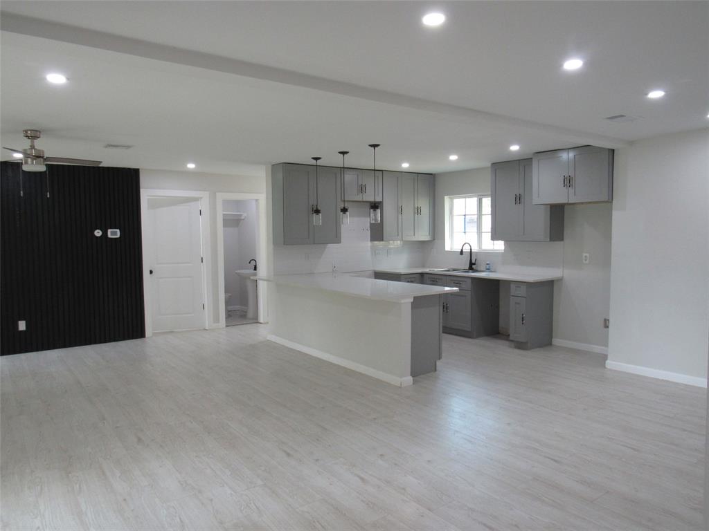 321 Crescent Drive Hewitt, TX 76643 - Photo 7 of 21 a kitchen with stainless steel appliances kitchen island granite countertop a refrigerator a sink a stove and white cabinets
