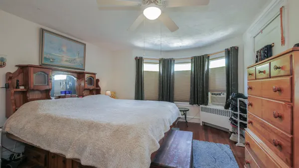 a bed room with a bed and a mirror