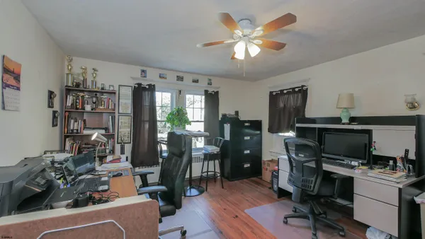a view of a workspace with furniture and a living room