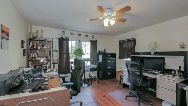 a view of a workspace with furniture and a living room