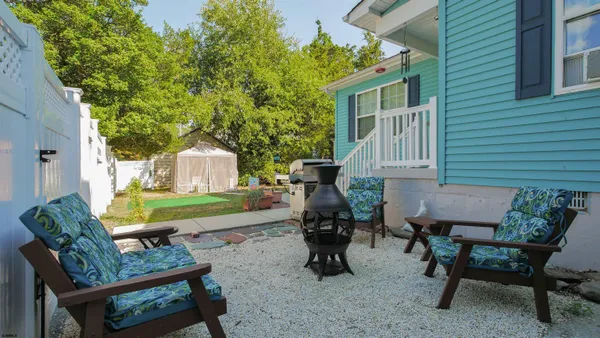 a view of a patio with table and chairs