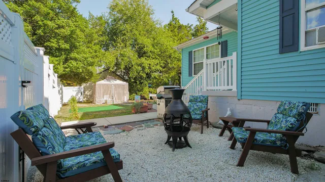 a view of a patio with table and chairs