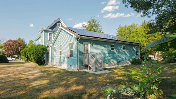 a front view of a house with a garden