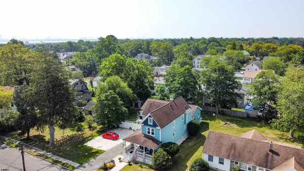 an aerial view of a house with swimming pool and lake view