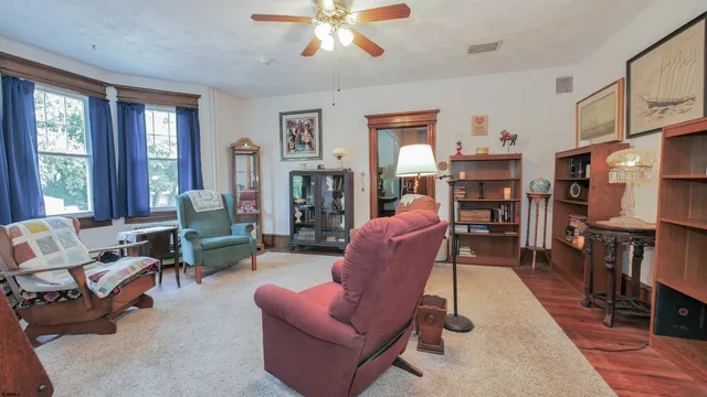 a living room with furniture a fireplace and a window