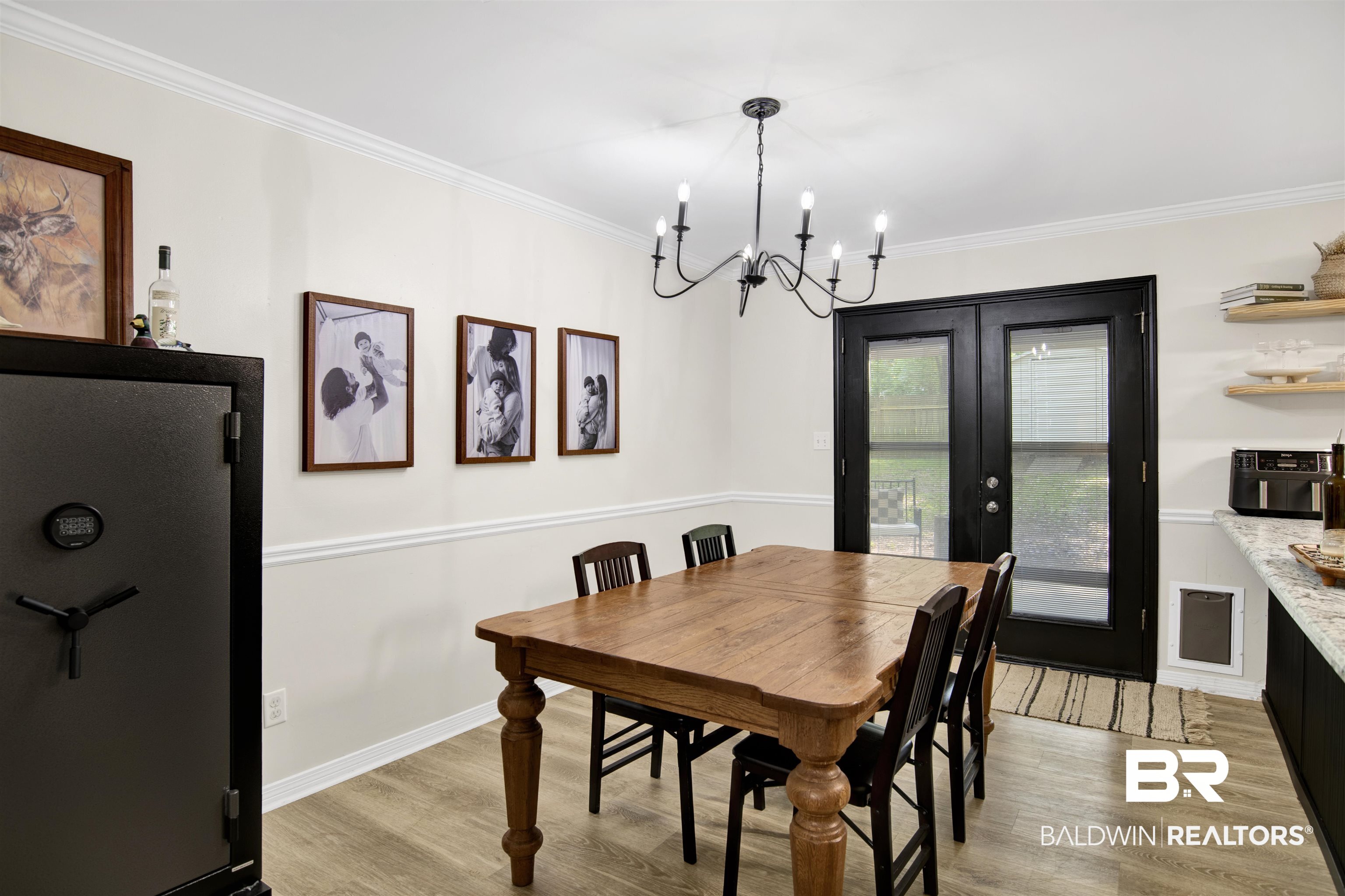 142 Richmond Road Daphne, AL 36526 - Photo 13 of 27 Dining space with light wood-style floors, a chandelier, french doors, ornamental molding, and baseboards