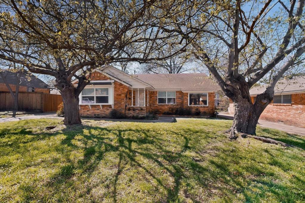 2120 Healey Drive Dallas, TX 75228 - Photo 1 of 39 a front view of a house with a yard
