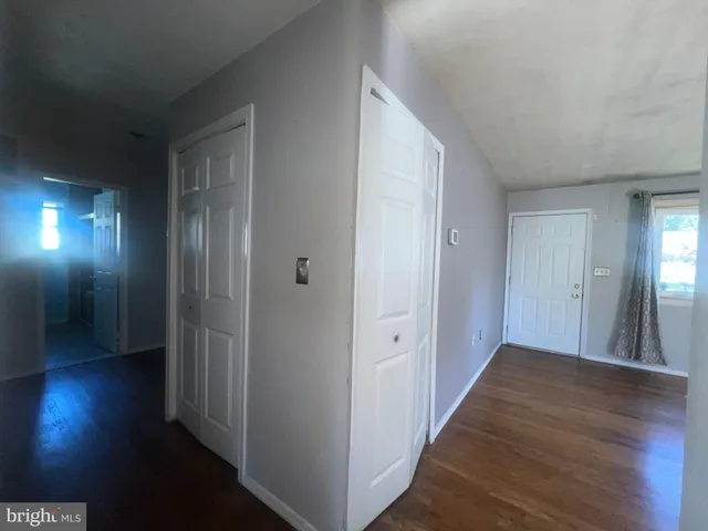 a view of hallway with wooden floor