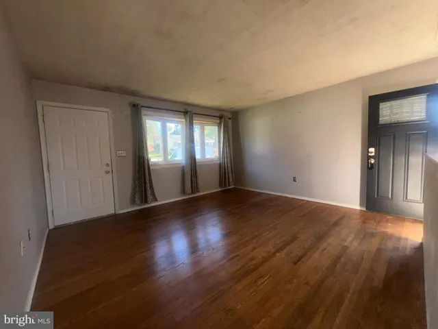 a view of wooden floor and windows in an empty room
