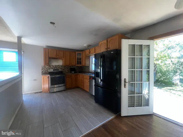 a kitchen with stainless steel appliances a refrigerator and a stove top oven